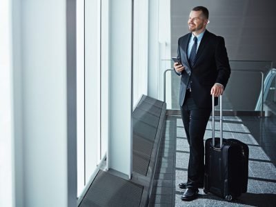 ideas-thinking-businessman-airport-with-phone-luggage-suitcase-travel-booking-vision-entrepreneur-corpor (1)